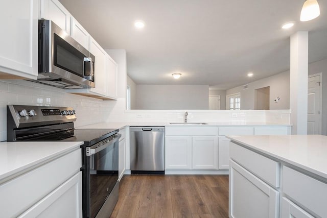 kitchen featuring white cabinetry, stainless steel appliances, sink, and tasteful backsplash