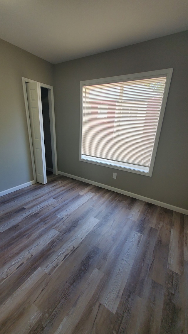 unfurnished bedroom with a closet and hardwood / wood-style flooring