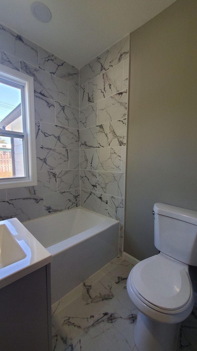 bathroom with vanity, toilet, and tile walls