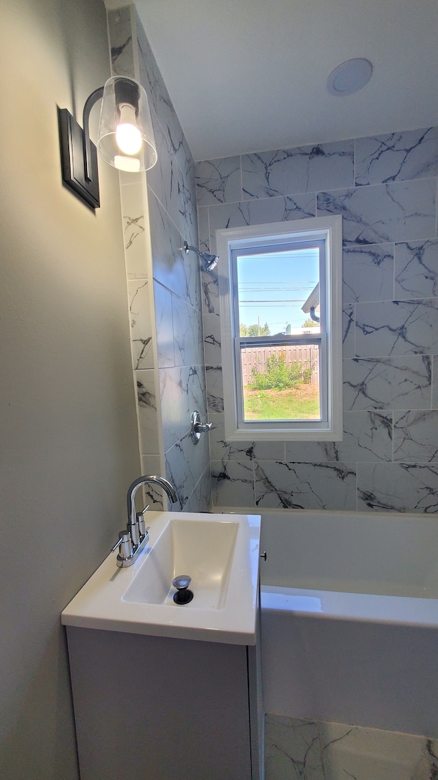 bathroom with vanity and tiled shower / bath combo