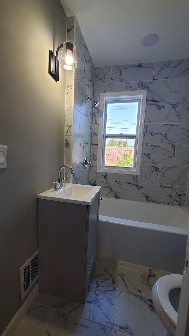 full bathroom featuring vanity, toilet, and tiled shower / bath combo