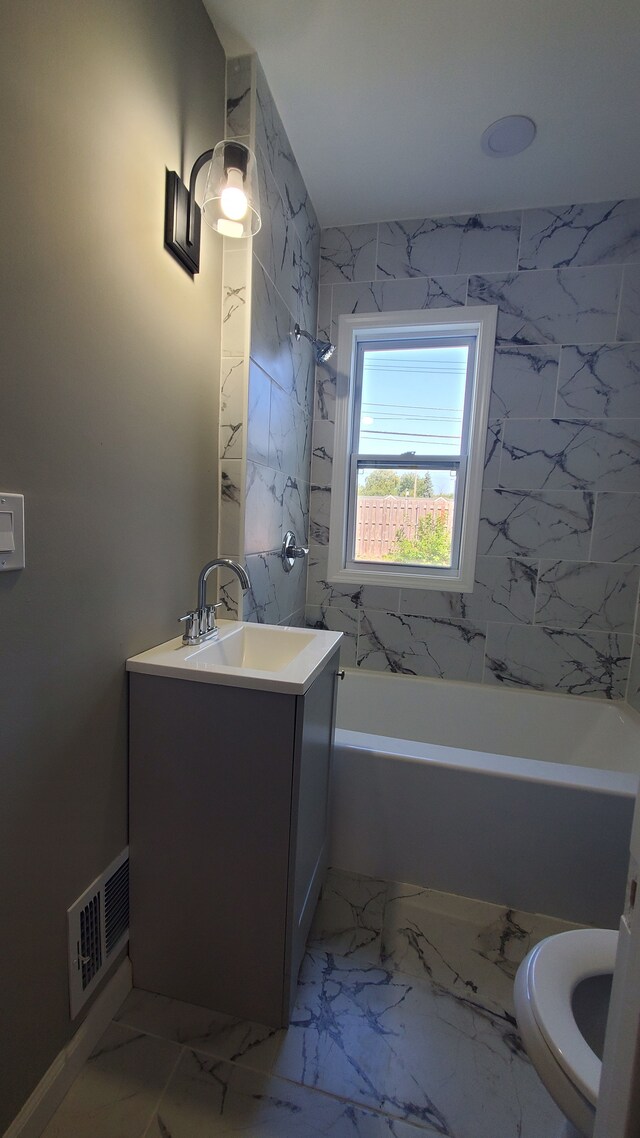 full bath with vanity, toilet, shower / bathtub combination, and marble finish floors