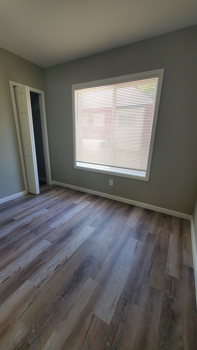 unfurnished bedroom with hardwood / wood-style flooring