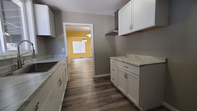 kitchen featuring a sink, dark wood-style floors, and white cabinets