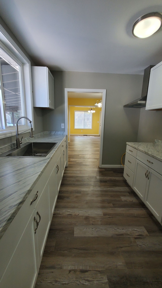 kitchen featuring white cabinets, light stone countertops, sink, and dark wood-type flooring