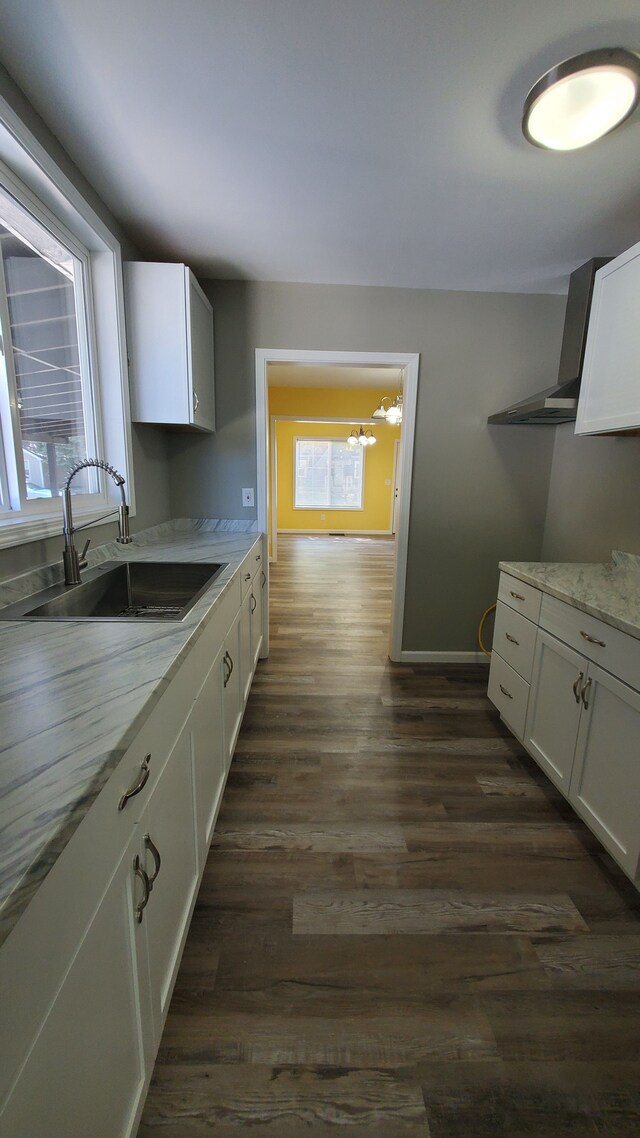 kitchen with a sink, white cabinetry, and dark wood finished floors