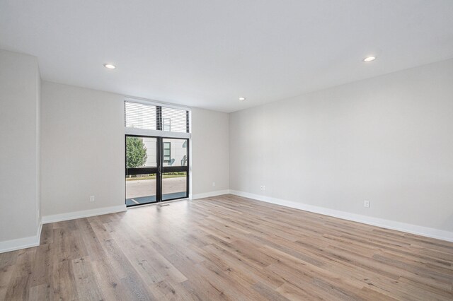 spare room with light hardwood / wood-style floors