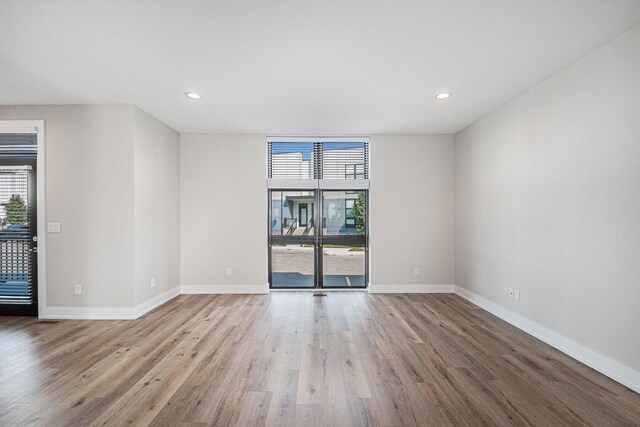 spare room with light hardwood / wood-style floors