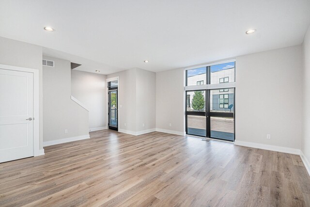 unfurnished room with light hardwood / wood-style floors