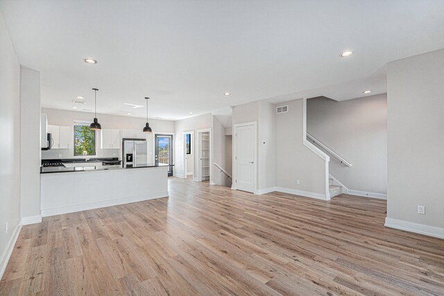 unfurnished living room featuring light wood-type flooring