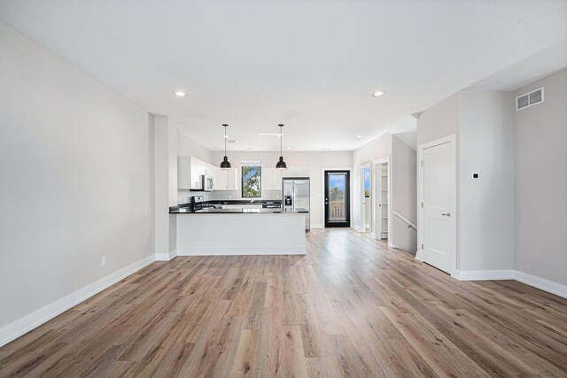 unfurnished living room with light hardwood / wood-style flooring