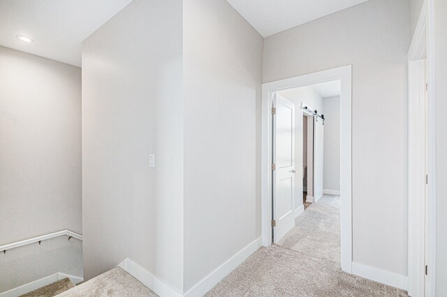 corridor with light colored carpet