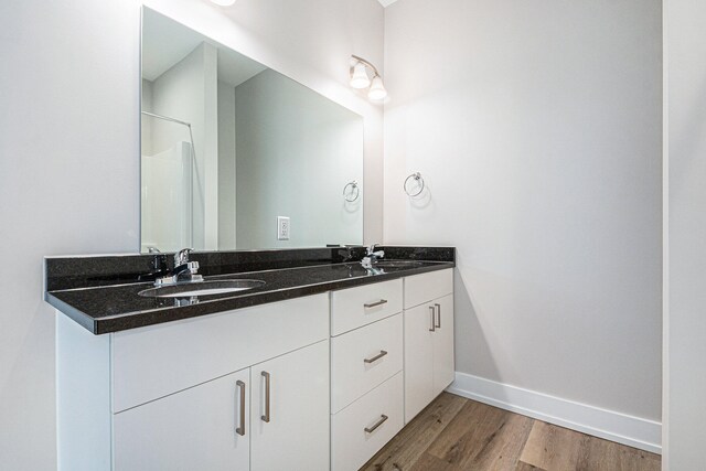 bathroom with hardwood / wood-style flooring and vanity