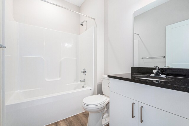 full bathroom with wood-type flooring, vanity, toilet, and shower / washtub combination