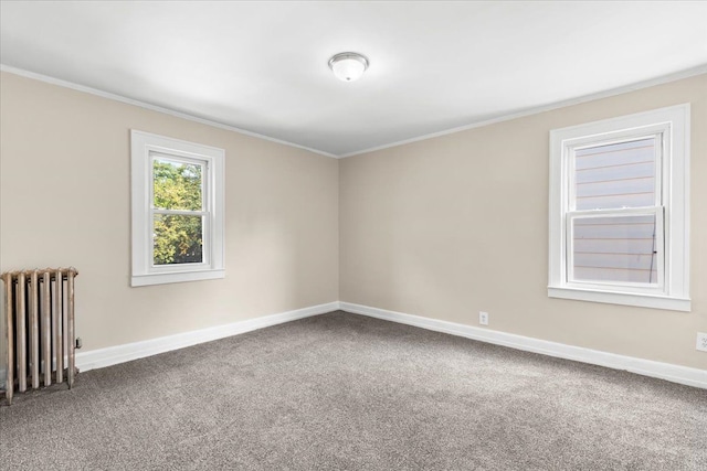 carpeted empty room with radiator heating unit and crown molding