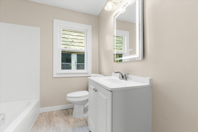 bathroom with vanity, toilet, and a bathtub