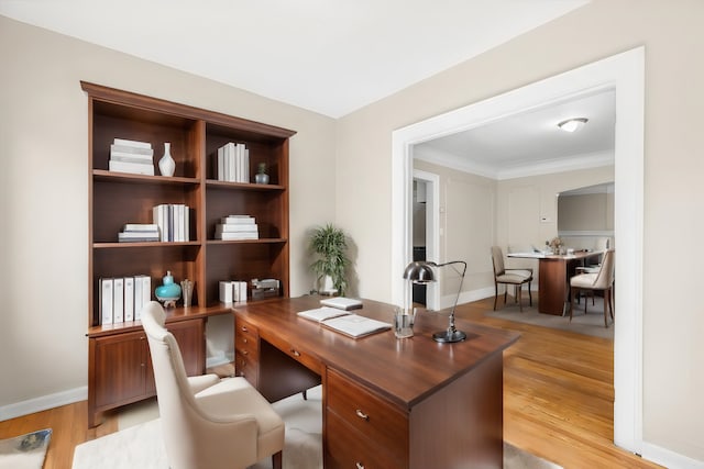 office featuring light hardwood / wood-style flooring and crown molding