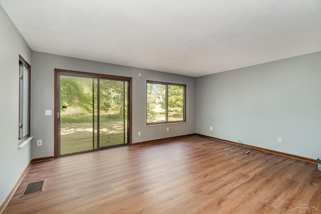 unfurnished room featuring light hardwood / wood-style floors