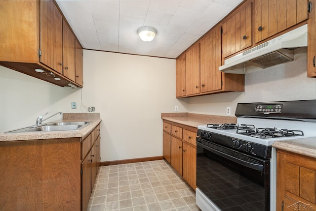 kitchen with white gas range and sink