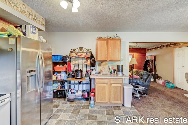 kitchen featuring stainless steel fridge, white electric range oven, light colored carpet, light brown cabinets, and a textured ceiling