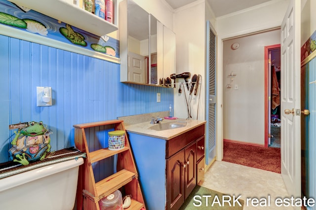 bathroom featuring vanity, ornamental molding, and toilet