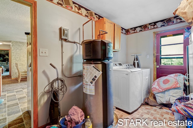 laundry room with washer and clothes dryer and cabinets