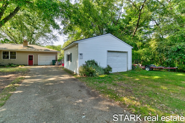 garage featuring a lawn