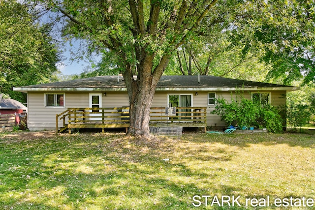 back of property featuring a yard and a deck