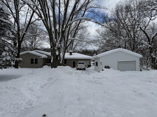 view of front facade featuring a garage and an outbuilding