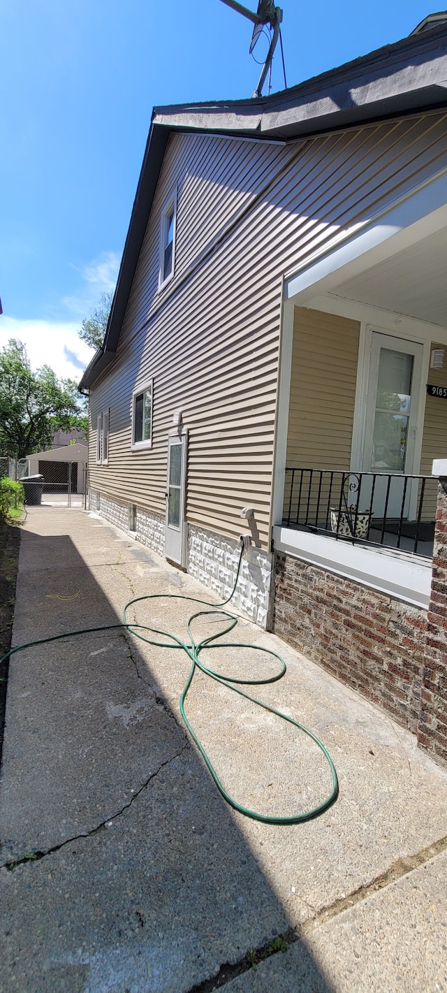 view of side of property featuring a patio area