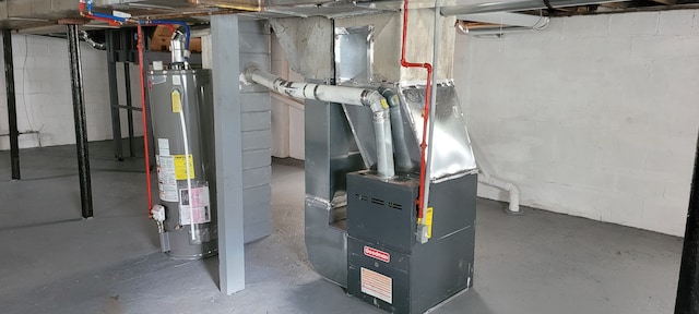 utility room featuring heating unit and gas water heater