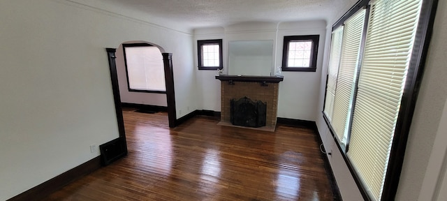 9185 Meyers Rd, Detroit, MI 48228 - unfurnished living room with dark wood-style flooring, a fireplace, and baseboards