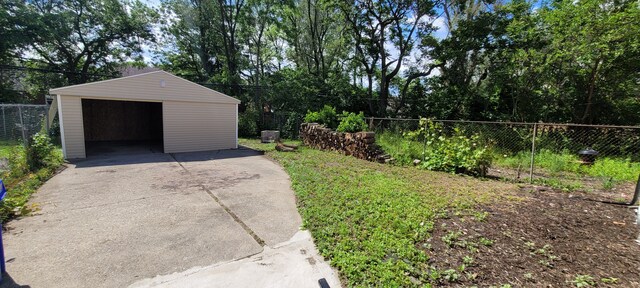 9185 Meyers Rd, Detroit, MI 48228 - view of yard featuring a detached garage, an outdoor structure, and driveway