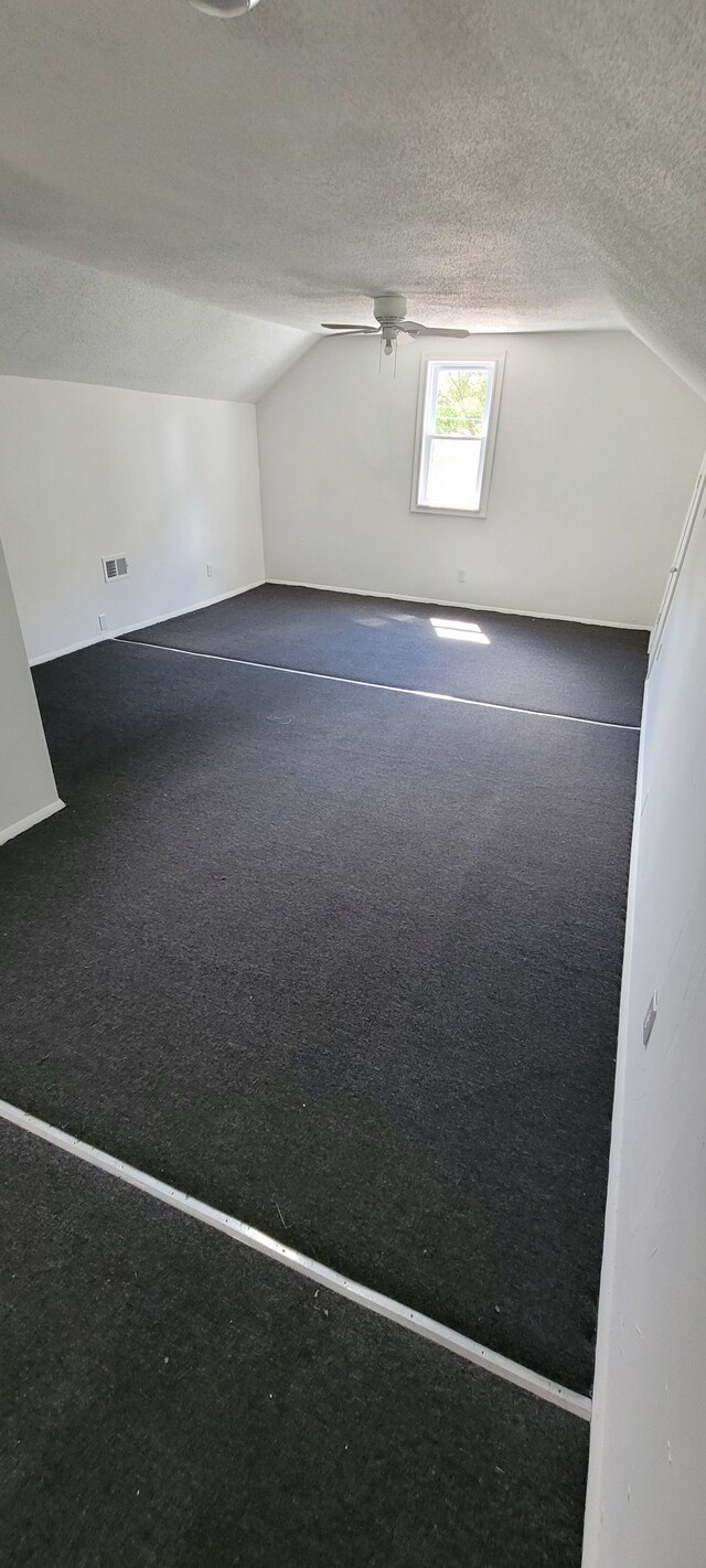 9185 Meyers Rd, Detroit, MI 48228 - additional living space featuring vaulted ceiling, a textured ceiling, and ceiling fan