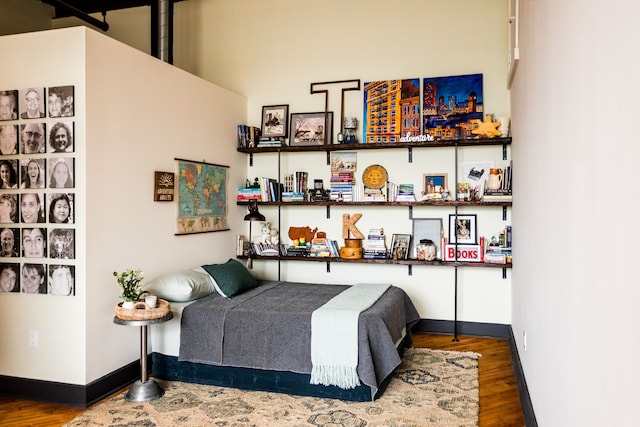 bedroom with wood finished floors and baseboards