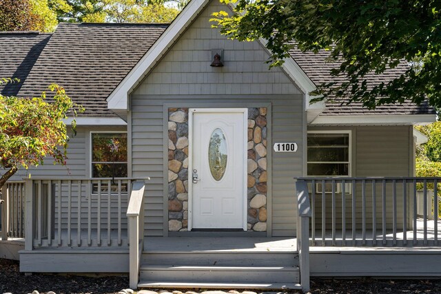 1100 Tisdale Rd, Roscommon, MI 48653 - view of exterior entry featuring a shingled roof