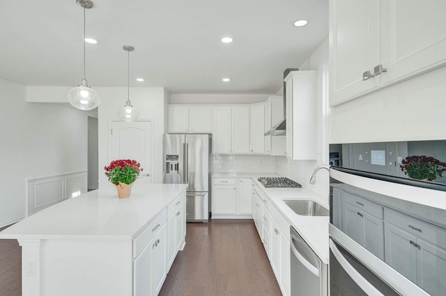 kitchen featuring a kitchen island, sink, white cabinetry, and stainless steel appliances