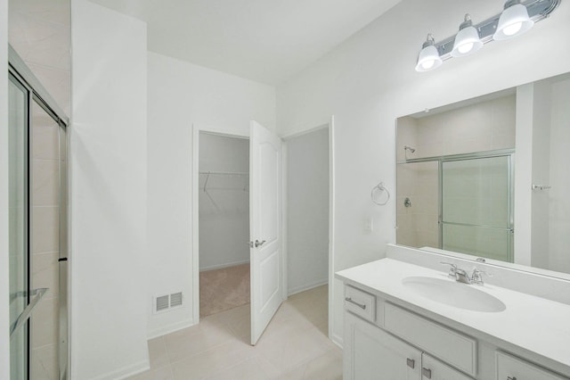 bathroom with vanity, tile patterned floors, and walk in shower