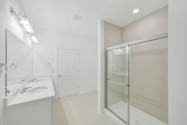 bathroom featuring tile patterned flooring, vanity, and a shower with shower door