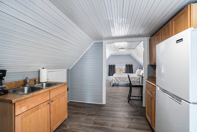 kitchen featuring sink, dark hardwood / wood-style floors, white fridge, vaulted ceiling, and wood ceiling