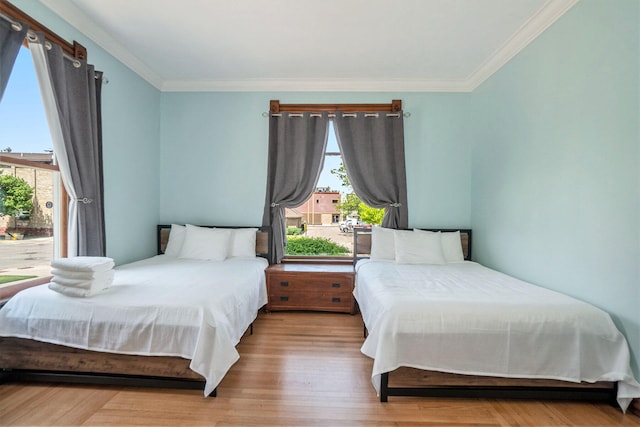 bedroom featuring hardwood / wood-style flooring and crown molding