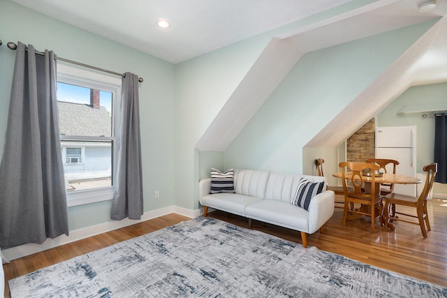 living room with hardwood / wood-style floors and vaulted ceiling