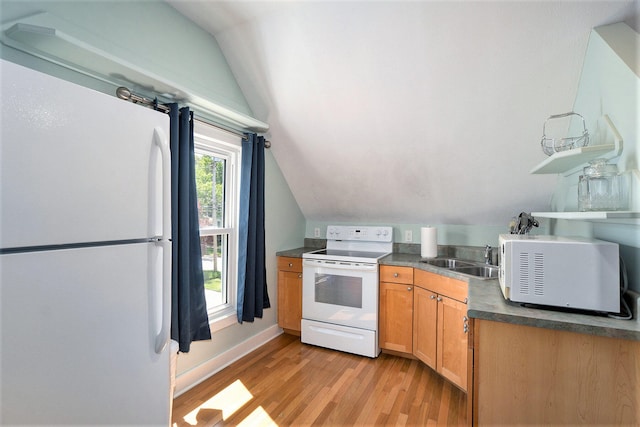 kitchen with lofted ceiling, light wood-type flooring, white appliances, and sink