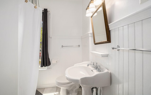 bathroom featuring sink, tile patterned flooring, and toilet