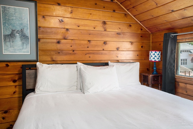 bedroom with wood walls, wood ceiling, and vaulted ceiling