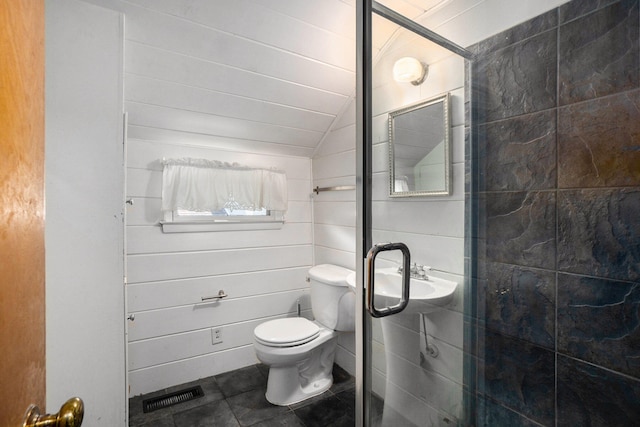 bathroom with toilet, tile patterned floors, vaulted ceiling, and walk in shower