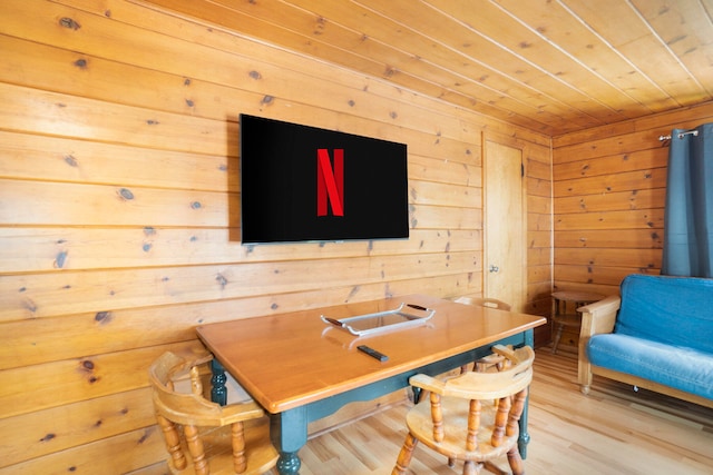 office area featuring wood walls and wood-type flooring