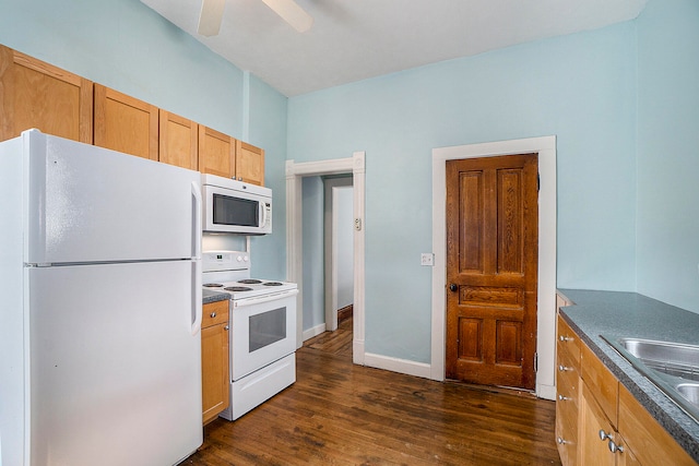 kitchen featuring white appliances, dark hardwood / wood-style floors, ceiling fan, and sink