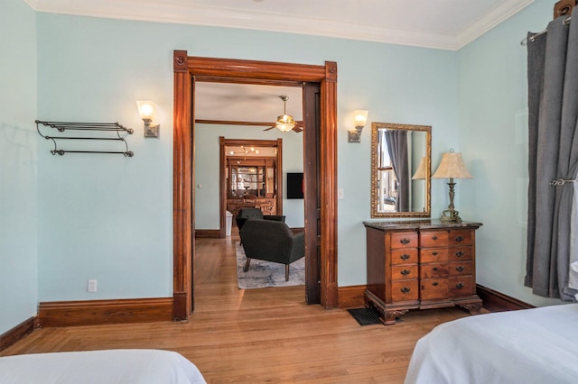 bedroom featuring light hardwood / wood-style flooring and ornamental molding