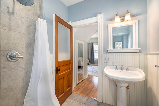 bathroom featuring hardwood / wood-style floors and walk in shower